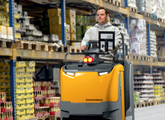 Stand up forklift for use in a warehouse